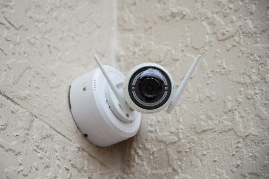 White surveillance camera mounted on an exterior wall