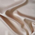 Close-up view of smooth white fabric texture